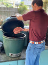 A man putting meat into a Big Bend by Zilker Belts.